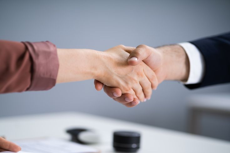 a solicitor and client shaking hands after a successful pagination